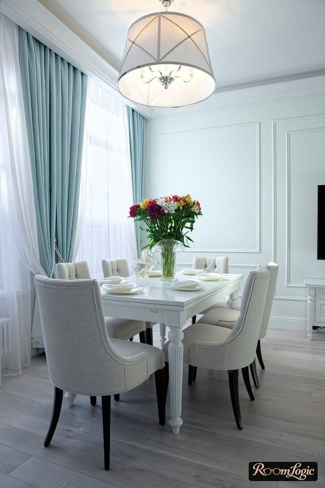 Light blue curtains in the kitchen-dining room in a classical style