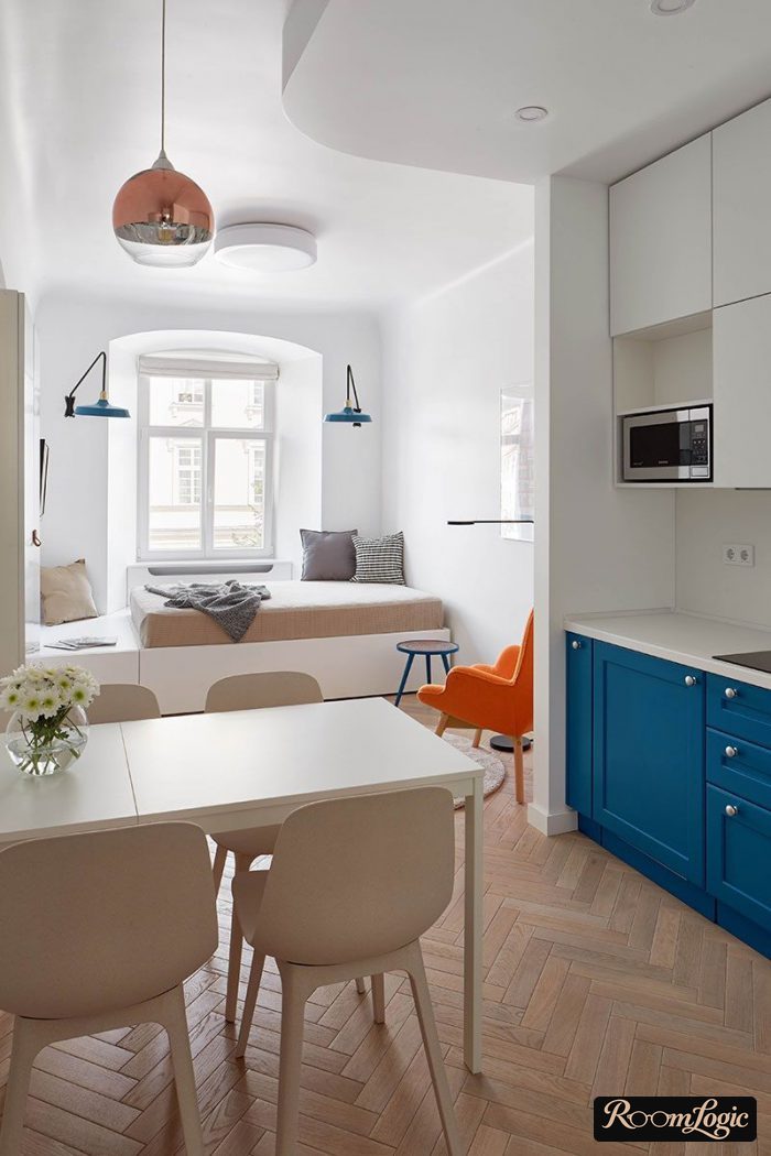 light blue kitchen-living room with orange accent