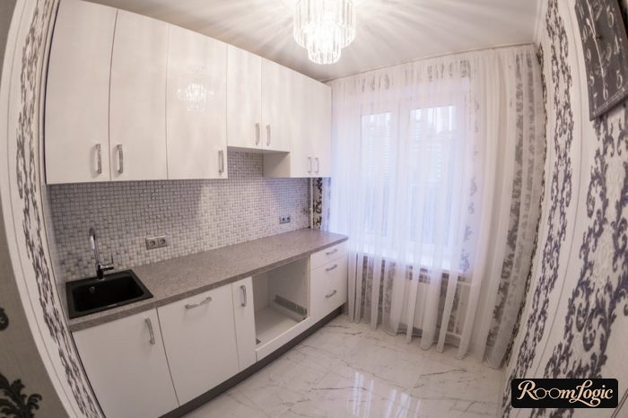linear white kitchen cabinets in a small kitchen