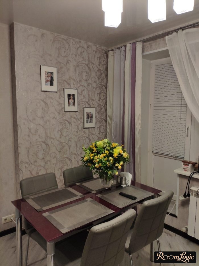 long curtains to the floor and sheer curtains in the kitchen with a balcony