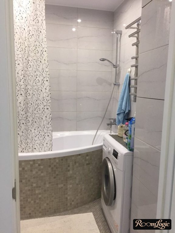 marble-look tile in white bathroom in tiny apartment