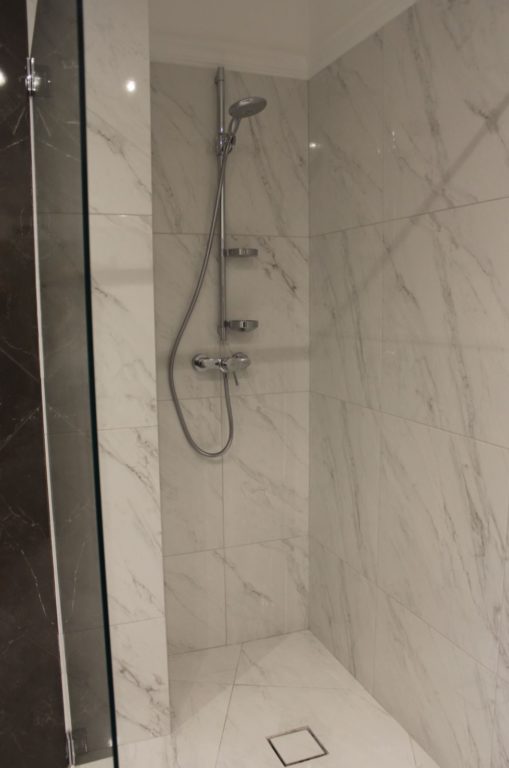 marble-look tile shower