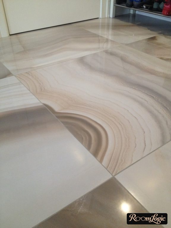 marble-look tile with gray grout on the floor in the entryway