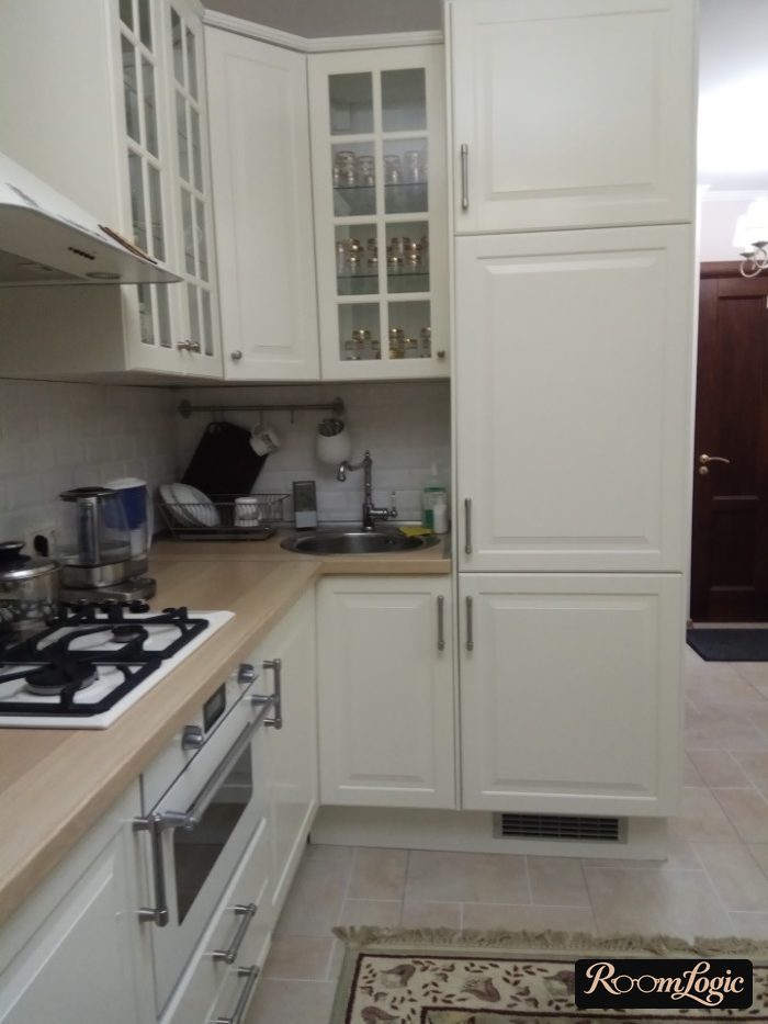 milky white kitchen with wooden countertop