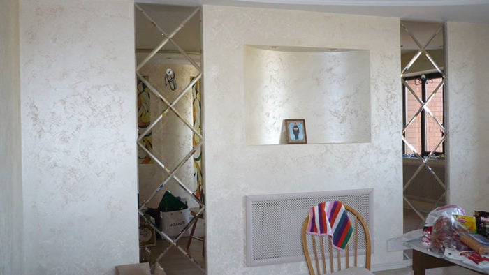 mirror with faceted frame and art deco textured plaster