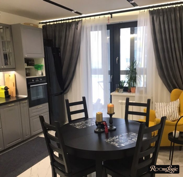 modern kitchen with balcony door and floor-length gray curtains