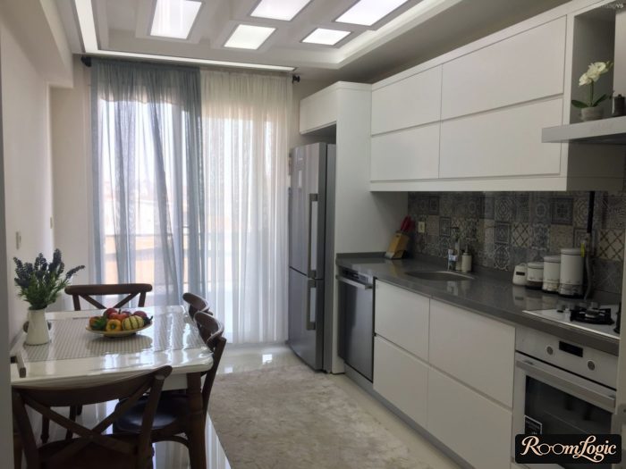 modern white kitchen with balcony and sheer curtain