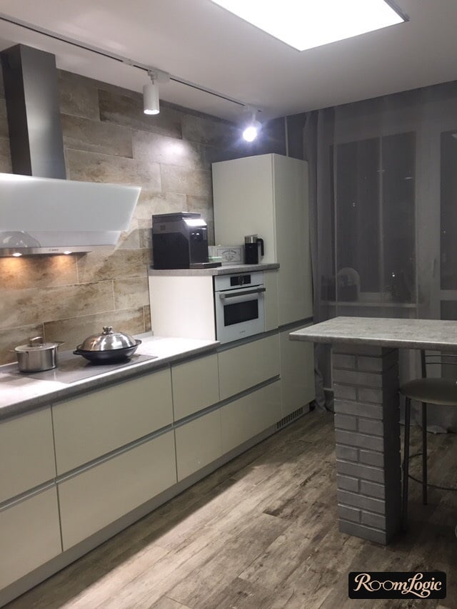 modern white kitchen with balcony and window decorated with sheer curtains