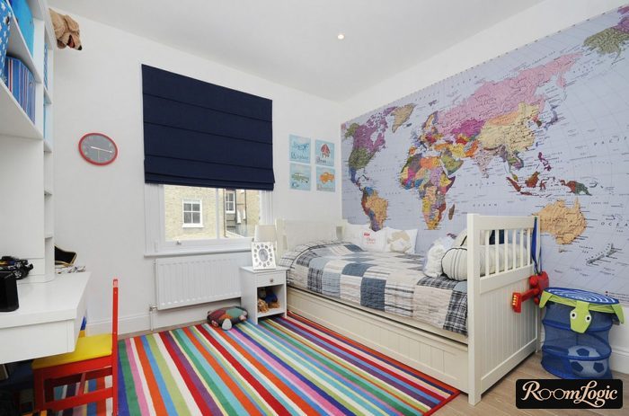 multicolored carpet and map on the wall in the interior of a boys' room