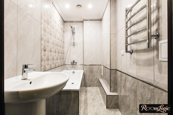 narrow bathroom with gray glossy tiles