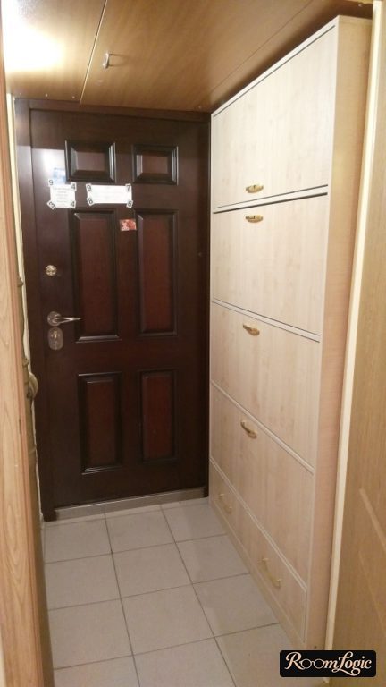 narrow overcoat hook reaching the ceiling in the entryway