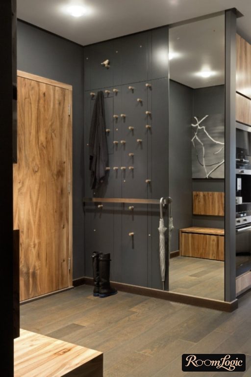 open coat hooks on the door of the entryway closet in a small hallway