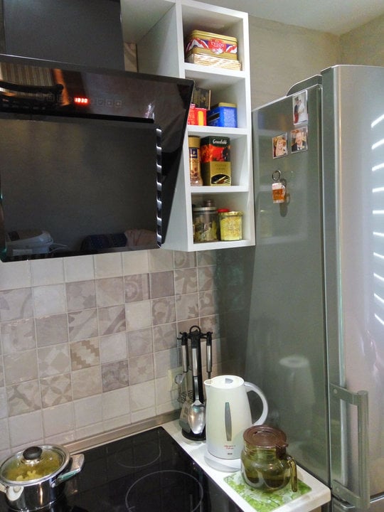 open shelves next to the refrigerator