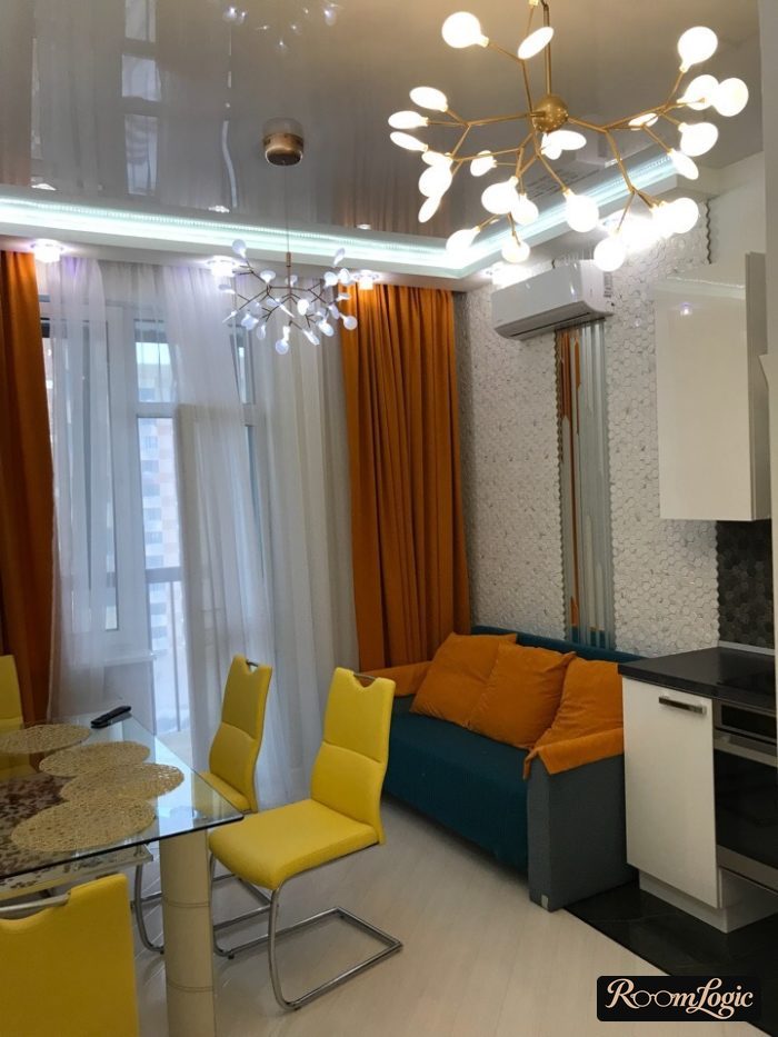 orange curtains on the kitchen with a balcony