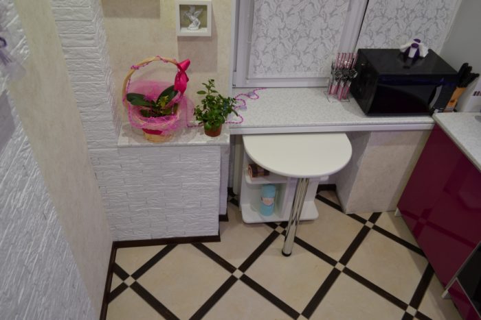 Pull-out breakfast bar from under the window in a tiny apartment