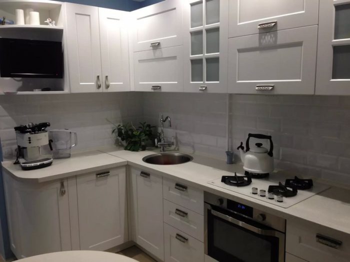 range hood above the gas stove in the kitchen of a tiny apartment