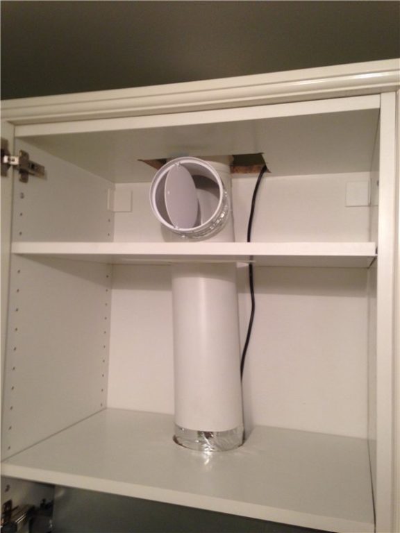 range hood connected through a tee with a reverse valve