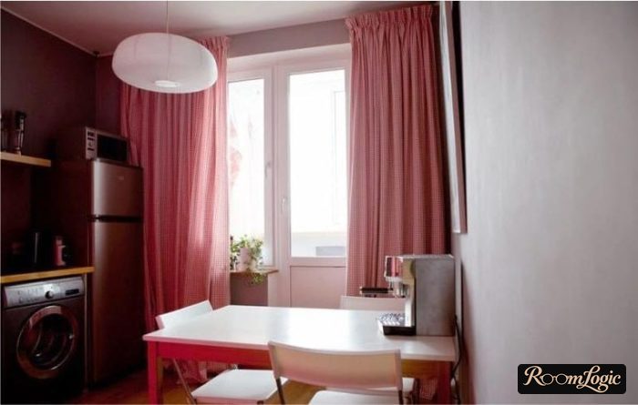 red curtains on a strip in the kitchen with a balcony door