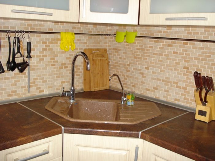sand-colored brick mosaic on the kitchen backsplash