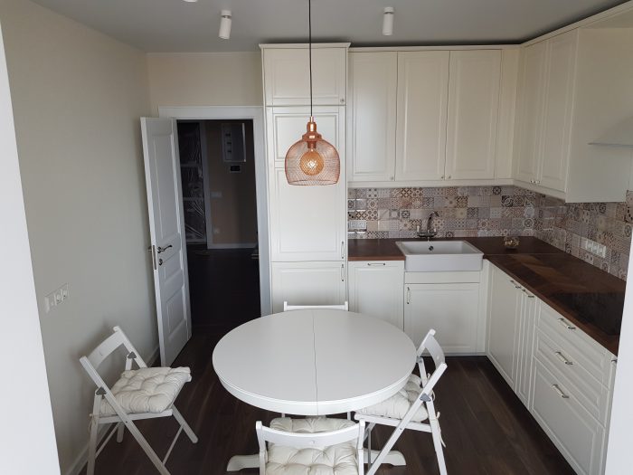 scandinavian kitchen with patchwork tile on backsplash