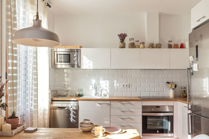 Subway tile on the white backsplash in a Scandinavian style kitchen