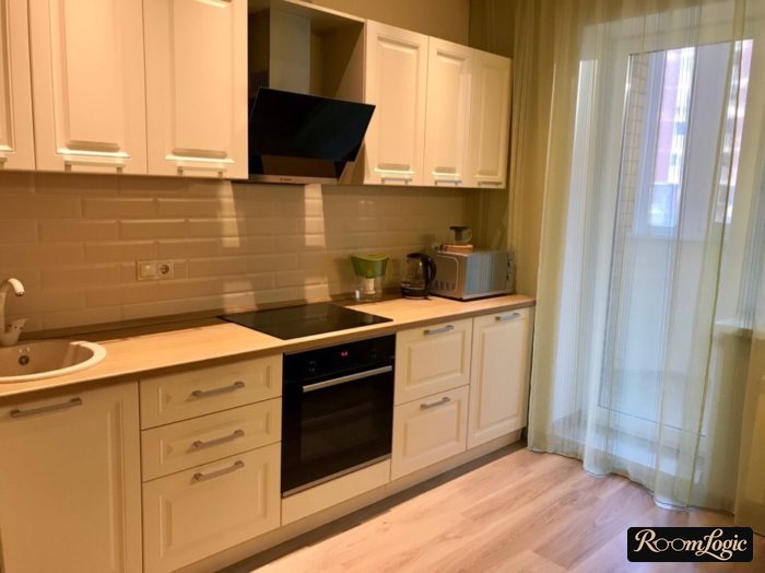 scandinavian styled kitchen with balcony and sheer curtain