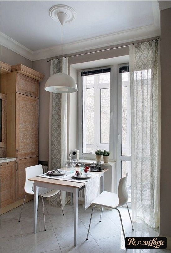 shades on a wall curtain rod in the kitchen with a balcony door
