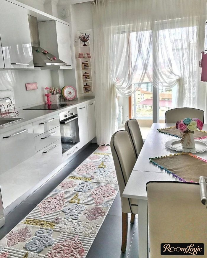 sheer curtain on curtain rods in a kitchen with a balcony