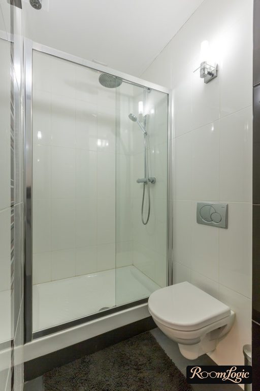 shower in small bathroom with toilet