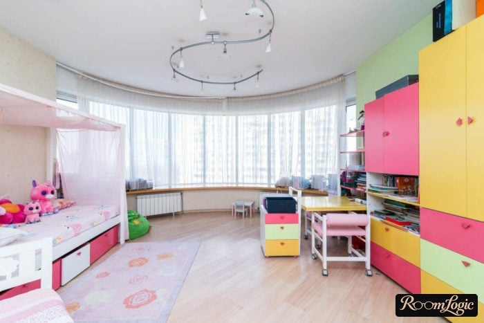 simple decor and bright furniture in a large kids' room