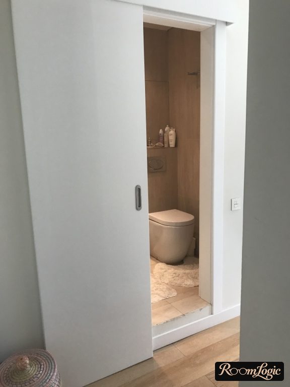 sliding door from small entryway to bathroom