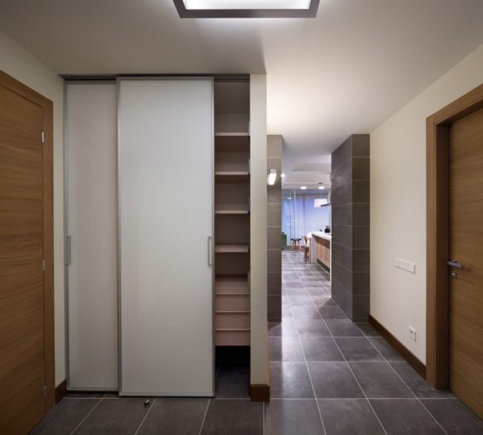 sliding-door wardrobe in the design of a real hallway in an apartment