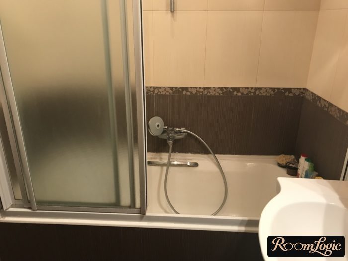 sliding glass curtain in bathroom of tiny apartment