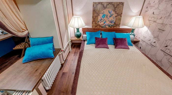 small bedroom with partial balcony attachment