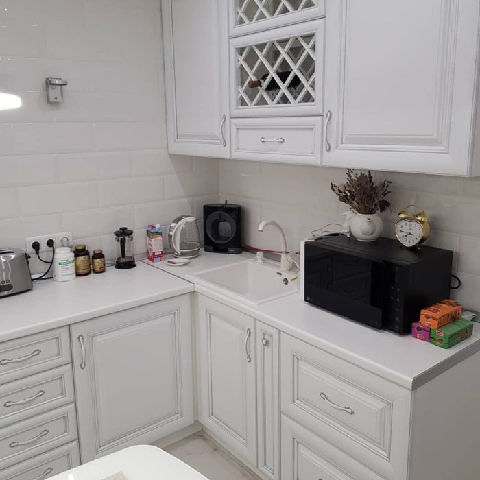 small corner kitchen with sink in the corner