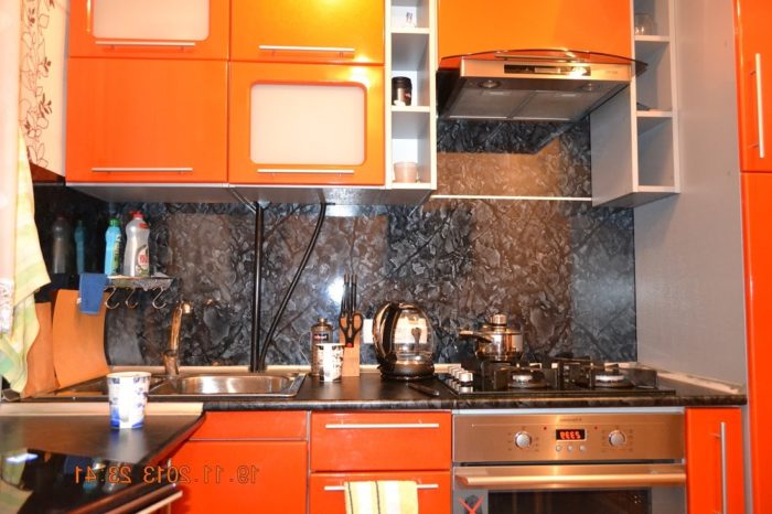 small kitchen with plastic backsplash in color of countertop