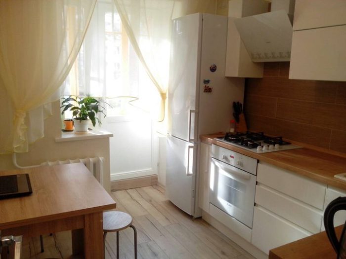 small kitchen with white cabinet and wood-look countertop