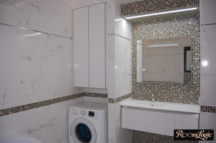 small white bathroom with a washer