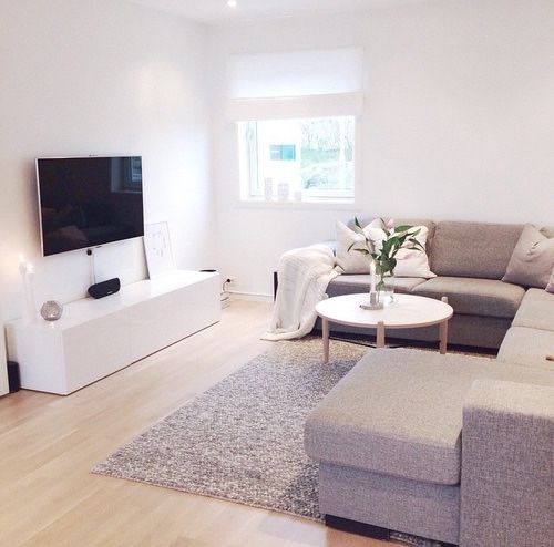 small white living room with round coffee table