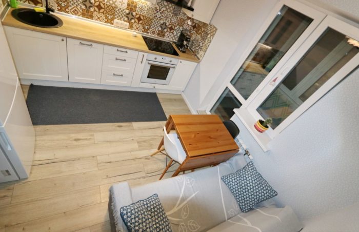 sofa in kitchen of one-bedroom apartment