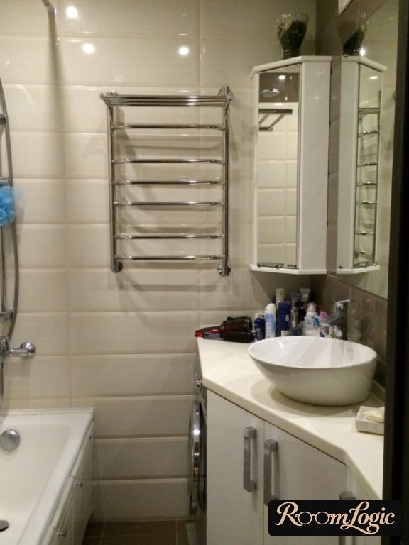 Subway tile in a small bathroom with a white cabinet