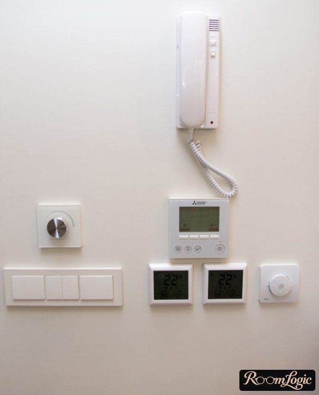 Switch block and intercom on the wall in the small entryway