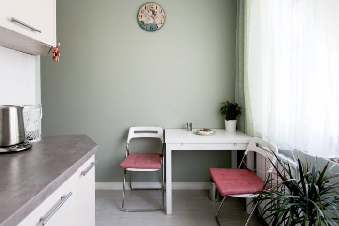 table nook in the corner of the kitchen in a tiny apartment