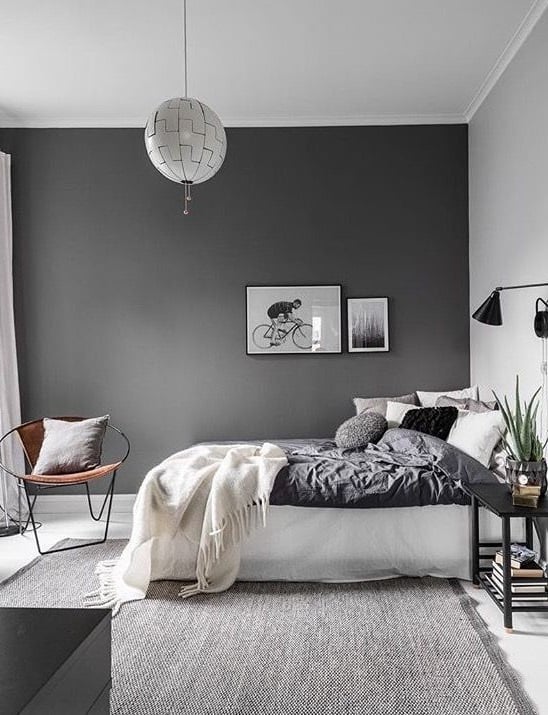 the walls in the bedroom are dark gray