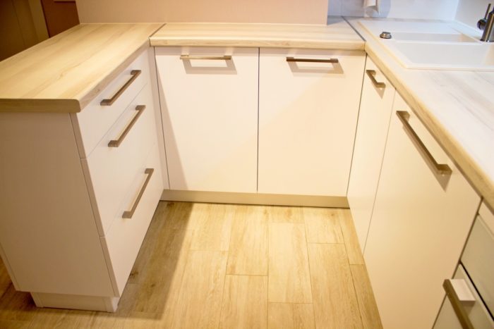 tile and wood-look countertop on a white kitchen