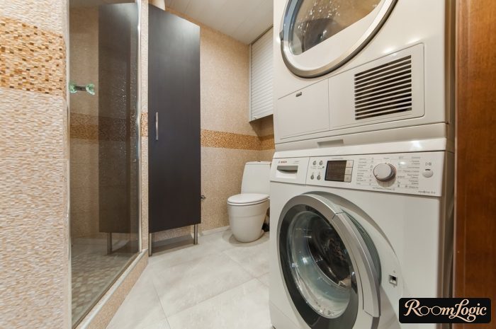 tile pixels in the bathroom with a washer and shower