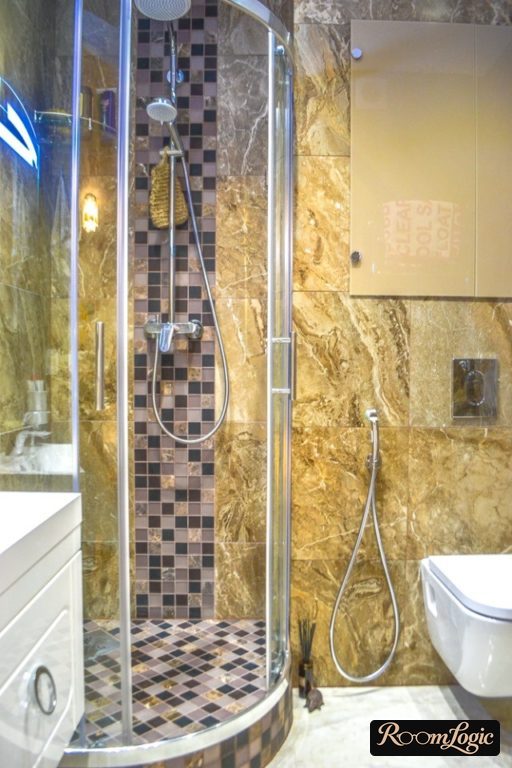 tile shower tray in a small bathroom with a toilet