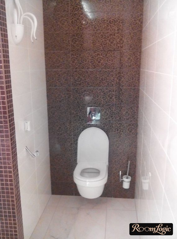 toilet brush on the wall