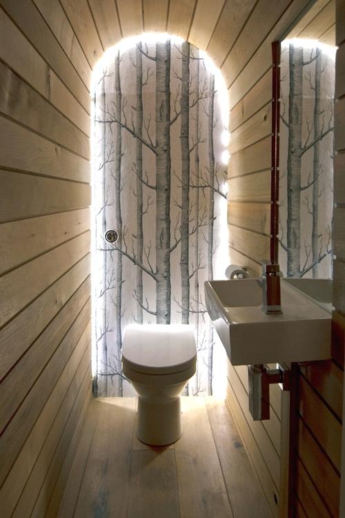 toilet with wooden finish and lighting