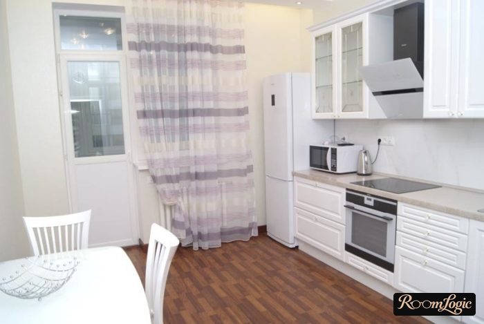 translucent curtains in the kitchen with a balcony door